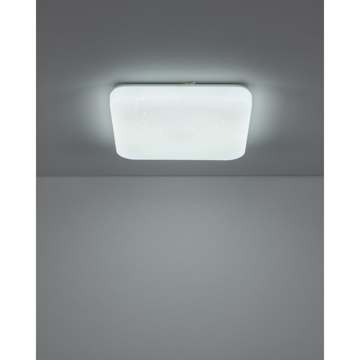 Crelvette square LED bathroom ceiling light in white, flush-mounted with a crystal effect diffuser, shown illuminated on a grey ceiling.
