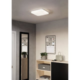 Crelvette square LED ceiling panel light, 33 x 33cm, white steel body with crystal-effect diffuser, shown flush-mounted on a hallway ceiling above a mirror and shelving unit.