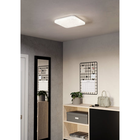 Crelvette square LED ceiling panel light, 33 x 33cm, white steel body with crystal-effect diffuser, shown flush-mounted on a hallway ceiling above a mirror and shelving unit.