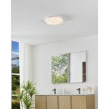 Crelvette LED Bathroom Ceiling Light 31cm in white, shown flush-mounted above a bathroom vanity with mirror, illuminating the space with a soft, even glow.