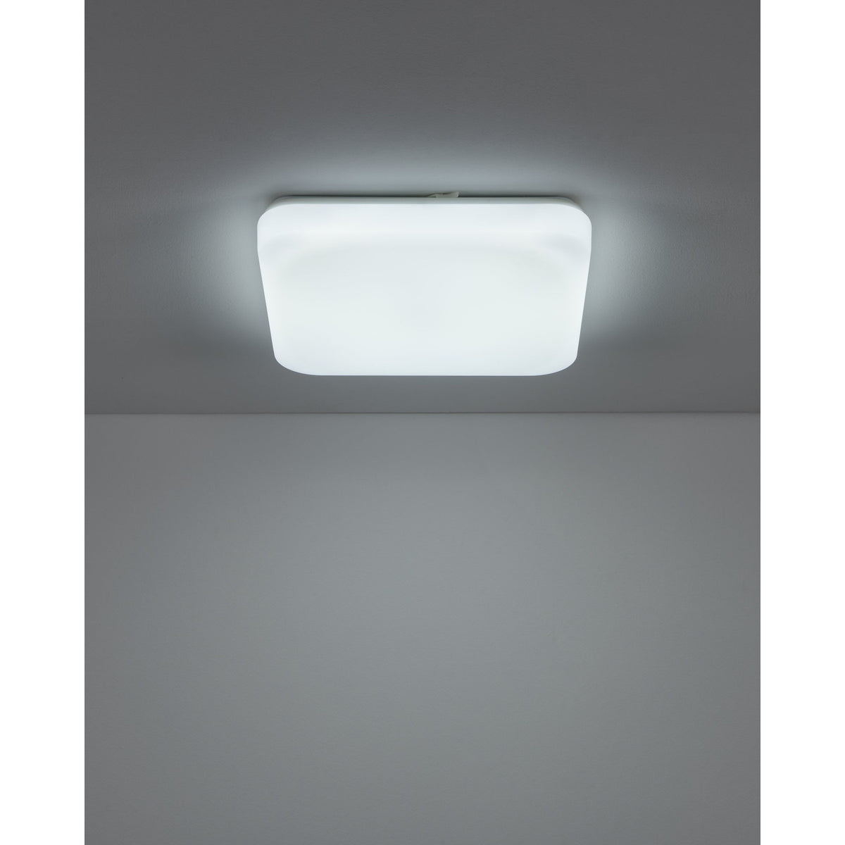 Crelvette LED Bathroom Ceiling Light, square flush fixture with white steel body and softly rounded white plastic diffuser, shown illuminated on a grey ceiling.