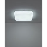 Crelvette LED Bathroom Ceiling Light, square flush fixture with white steel body and softly rounded white plastic diffuser, shown illuminated on a grey ceiling.