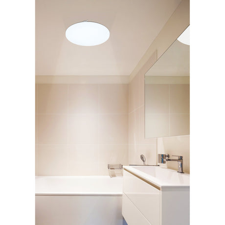 Crelvette LED Bathroom Ceiling Light, 33cm round white flush fitting with plastic shade, shown installed on a bathroom ceiling above a white vanity and tiled wall.