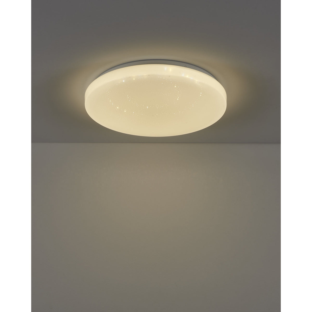 Crelvette 43cm round LED flush ceiling light with white steel body and crystal-effect diffuser, glowing warm white on a grey ceiling.