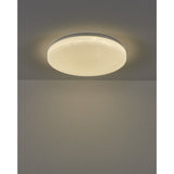 Crelvette 43cm round LED flush ceiling light with white steel body and crystal-effect diffuser, glowing warm white on a grey ceiling.