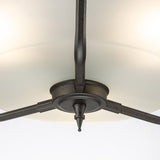 Detailed view of the Crown 3 Light Semi Flush - Graphite, designed with a brushed metal finish. This lighting fixture boasts a central round base and three supporting arms, enhanced by frosted glass shades that gently diffuse the light, highlighting its modern and minimalist architectural style.