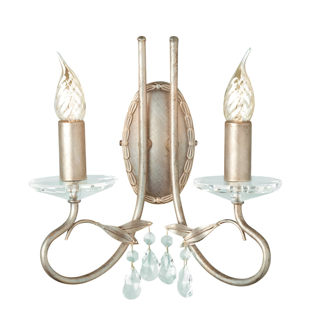 The Christina 2 Light Wall Light - Silver/Gold Patina showcases a vintage-inspired design with two candle-shaped bulbs, elegantly curved arms, and stunning crystal drops. Its ornate oval base is enhanced by a silver and gold patina finish, bringing an elegant, antique charm to any space.