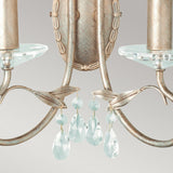 Close-up of the Christina 2 Light Wall Light in a silver and gold patina finish, showcasing two glass candle holders and delicate crystal drops. The fixture features an elegant vintage design against a soft grey background.