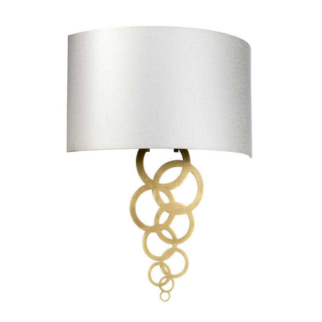 The Curtis Large Wall Light in aged brass showcases a modern design with a white cylindrical lampshade, enhanced by an elegant chain of interlocking gold rings for an exquisite decorative lighting fixture.