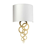 The Curtis Medium Wall Light - Aged Brass showcases a contemporary aesthetic with a white, semi-cylindrical lampshade highlighted by aged brass and adorned with elegantly hanging interlocking gold rings.