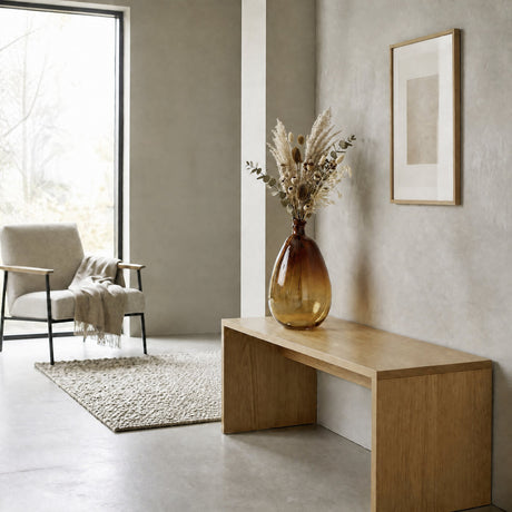 Dahukeng Vase 47cm in rust ombre glass with a teardrop shape and narrow neck, holding dried pampas grass stems on a wooden bench in a living room.