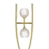 The Dali 2 Light Floor Lamp features a polished brass U-shaped frame holding two frosted, patterned glass or crystal spheres stacked vertically on slim horizontal bars for a modern, minimalist look.
