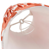 Close-up of the Daneton 16cm tapered lamp shade in apricot orange with pleated zigzag fabric, taped edge, pale lining, and candle clip fitting.