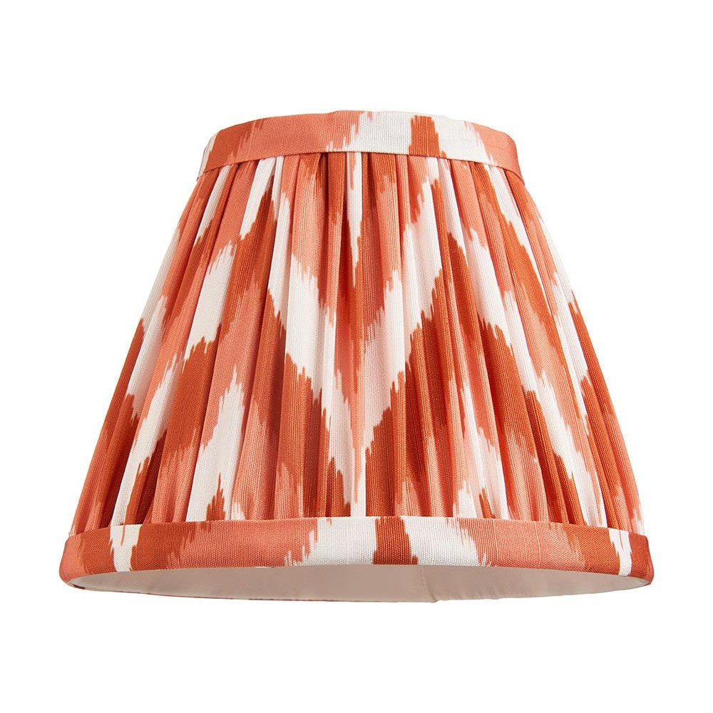 Daneton 16cm tapered lamp shade in apricot orange, handmade pleated faux silk with zigzag pattern and taped edges, shown on a plain white background.
