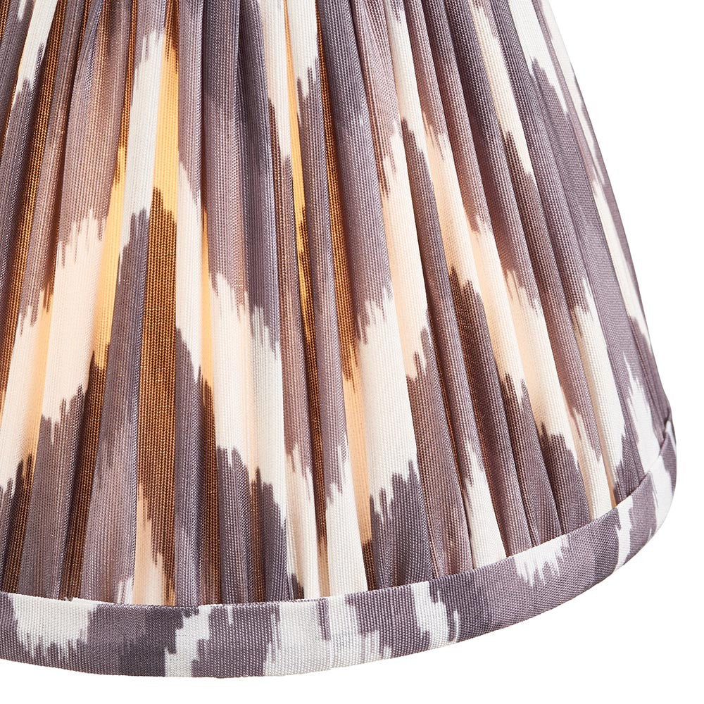 Close-up of Endon Daneton 16cm tapered lamp shade in pearl grey, showing pleated faux silk with a grey and cream zigzag print and taped hem.