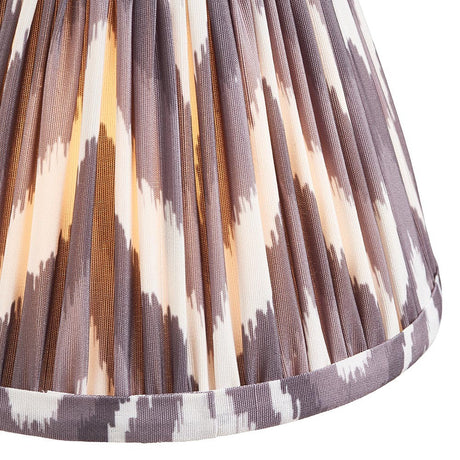 Close-up of Endon Daneton 16cm tapered lamp shade in pearl grey, showing pleated faux silk with a grey and cream zigzag print and taped hem.