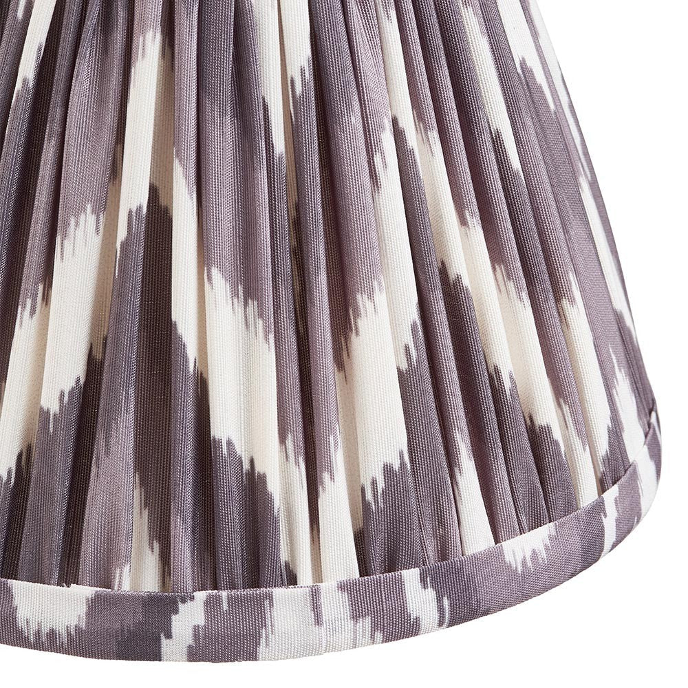 Close-up of Endon's Daneton 16cm tapered lamp shade in pearl grey, showing the pleated faux silk with grey and white zigzag print and taped hem.