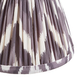 Close-up of Endon's Daneton 16cm tapered lamp shade in pearl grey, showing the pleated faux silk with grey and white zigzag print and taped hem.