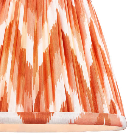 Endon Daneton 20cm tapered lamp shade in apricot orange and white, close-up of the pleated faux silk with zigzag print and taped bottom edge.