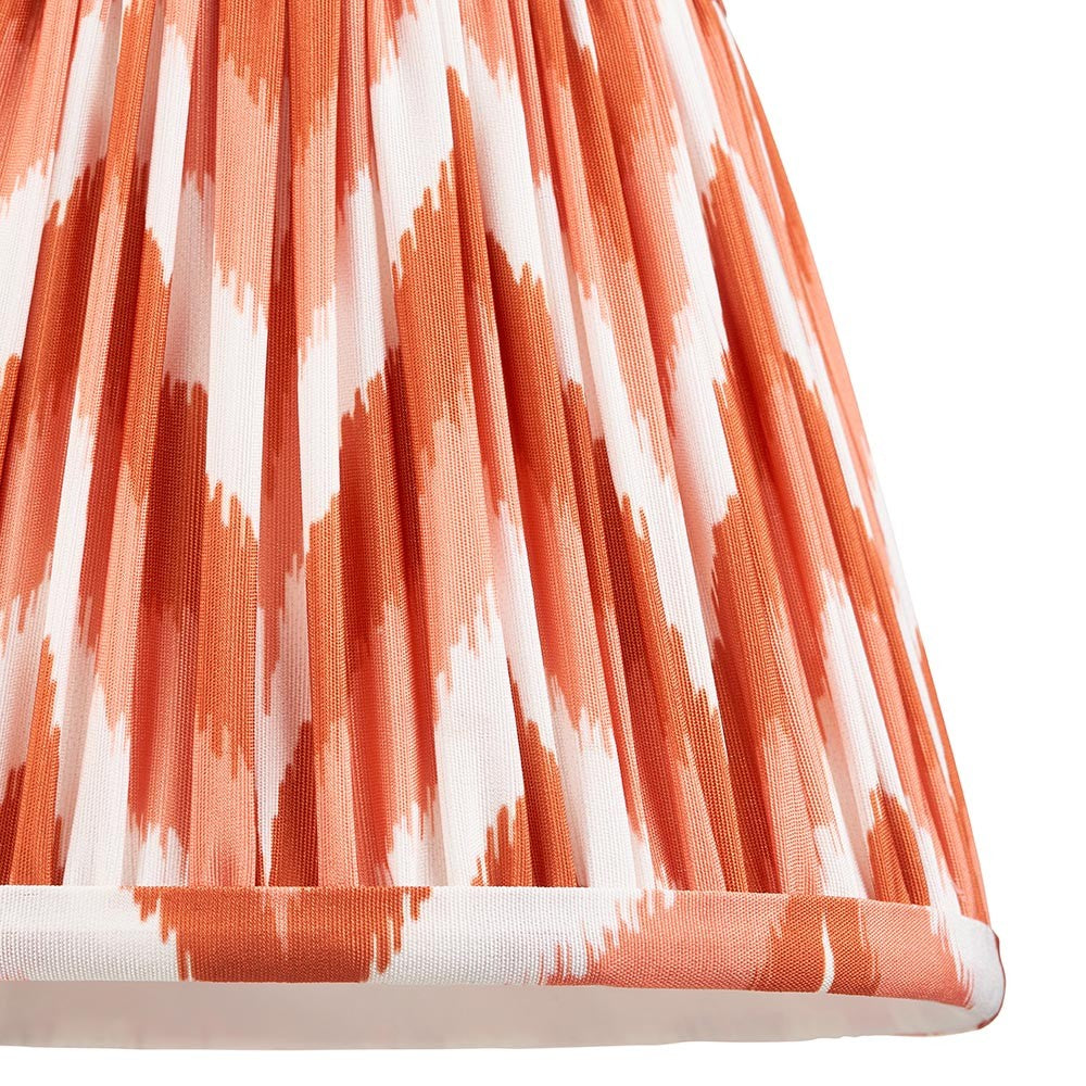 Endon Daneton 20cm tapered lamp shade in apricot orange and white zigzag pleated faux silk, close-up of the gathered lower edge with taped trim.