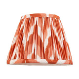 Endon Daneton 20cm tapered lamp shade in apricot orange and white zigzag pleated faux silk with taped edge trim, shown on a plain white background.