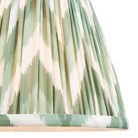 Close-up of Endon Daneton 20cm tapered lamp shade in Cotswold green and white zigzag pleated faux silk with taped edge detailing.
