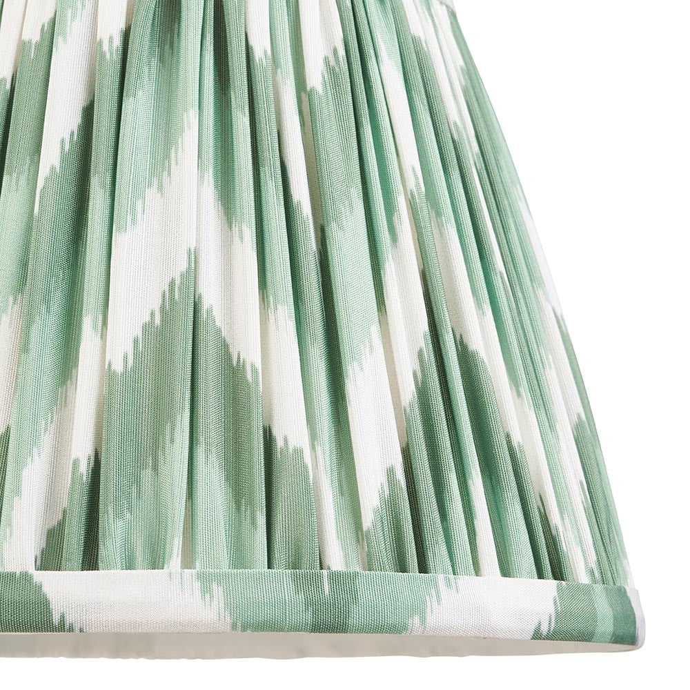 Endon Daneton 20cm tapered lamp shade in Cotswold green, close-up of the pleated faux silk with a green and white zigzag print and taped edge.
