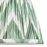 Endon Daneton 20cm tapered lamp shade in Cotswold green, close-up of the pleated faux silk with a green and white zigzag print and taped edge.