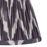 Close-up of the Endon Daneton 20cm tapered lamp shade in pearl grey, showing pleated faux silk with a zigzag print and taped edge trim.