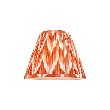 Endon Daneton 25cm tapered lamp shade in pleated faux silk with an apricot orange and white zigzag print and taped edges, on a plain background.