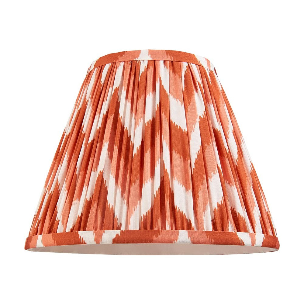 Endon Daneton 25cm tapered lamp shade in apricot orange and white pleated faux silk with zigzag print and taped edges, on a plain white background.