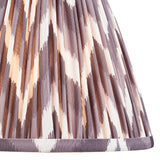Endon Daneton 25cm tapered lamp shade in pearl grey pleated faux silk with a zigzag print and taped edge detailing, shown in close-up.
