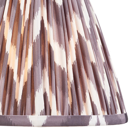 Endon Daneton 25cm tapered lamp shade in pearl grey pleated faux silk with a zigzag print and taped edge detailing, shown in close-up.