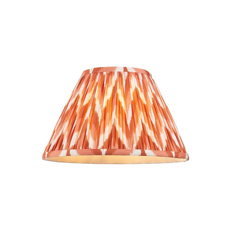 Endon Daneton 30cm tapered lamp shade in pleated apricot orange faux silk with a white zigzag print and taped edges, on a plain background.