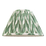 Endon Daneton 30cm tapered lamp shade in Cotswold green and white zigzag pleated faux silk with taped edging, shown on a plain white background.