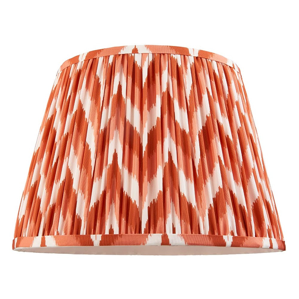 Endon Daneton 35cm tapered lamp shade in pleated faux silk with an apricot orange and white zigzag print and taped edging, on a white background.