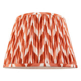 Endon Daneton 35cm tapered lamp shade in pleated faux silk with an apricot orange and white zigzag print and taped edging, on a white background.