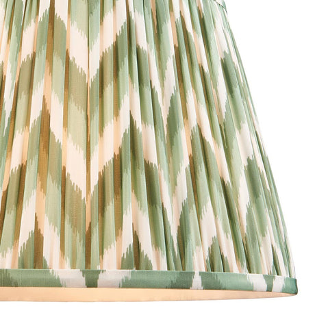 Endon Daneton 35cm tapered lamp shade in Cotswold green, close-up of the pleated faux silk with a zigzag print in green and cream and taped edging.