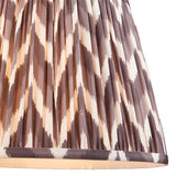 Endon Daneton 35cm tapered lamp shade in pearl grey pleated faux silk with a zigzag print and taped edge detailing, shown close-up.