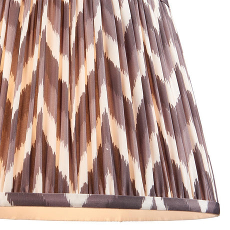 Endon Daneton 35cm tapered lamp shade in pearl grey pleated faux silk with a zigzag print and taped edge detailing, shown close-up.
