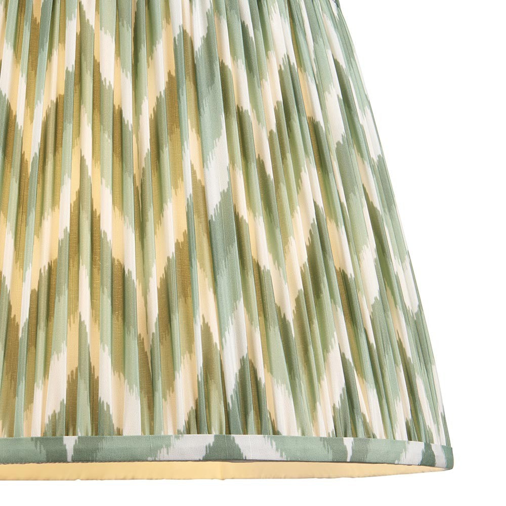 Endon Daneton 40cm tapered lamp shade in Cotswold Green, close-up of pleated faux silk with green, cream and olive zigzag print and taped edging.