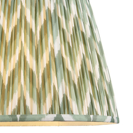 Endon Daneton 40cm tapered lamp shade in Cotswold Green, close-up of pleated faux silk with green, cream and olive zigzag print and taped edging.