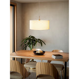 Dernessa Fabric Pendant Light 53cm in satin nickel with a white drum shade, shown lit above a wooden dining table in a neutral-toned dining room.