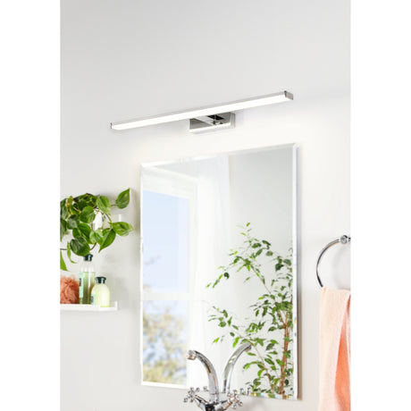 Dervette LED Bathroom Wall Light 60cm in chrome and silver mounted above a mirror, showing the slim bar fixture with white diffuser on a squared chrome bracket in a bathroom setting.