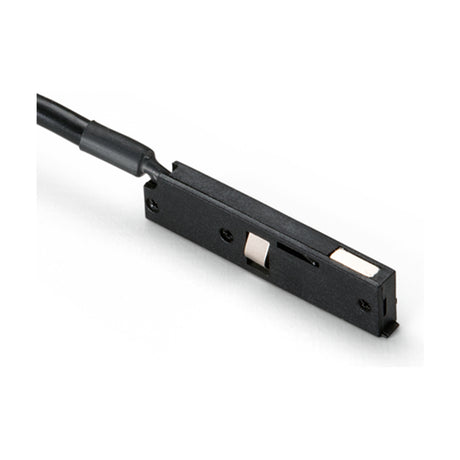 Deva 24V Track Power Feed in black, a slim rectangular connector with a black cable lead, screw fixing points, and metal contacts, shown on a plain white background.