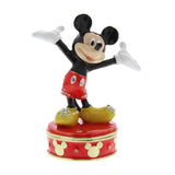 Red round trinket box with hinged lid featuring Mickey Mouse standing with arms outstretched, wearing red shorts, yellow shoes, and white gloves.