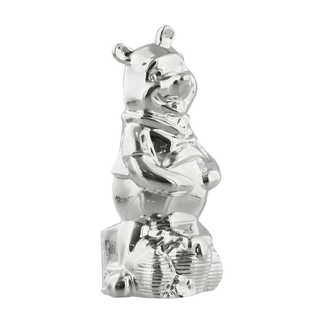 Standing Winnie the Pooh silverplated money box, mirror-finish figure with paws on tummy and rounded ears, on a plain white background.