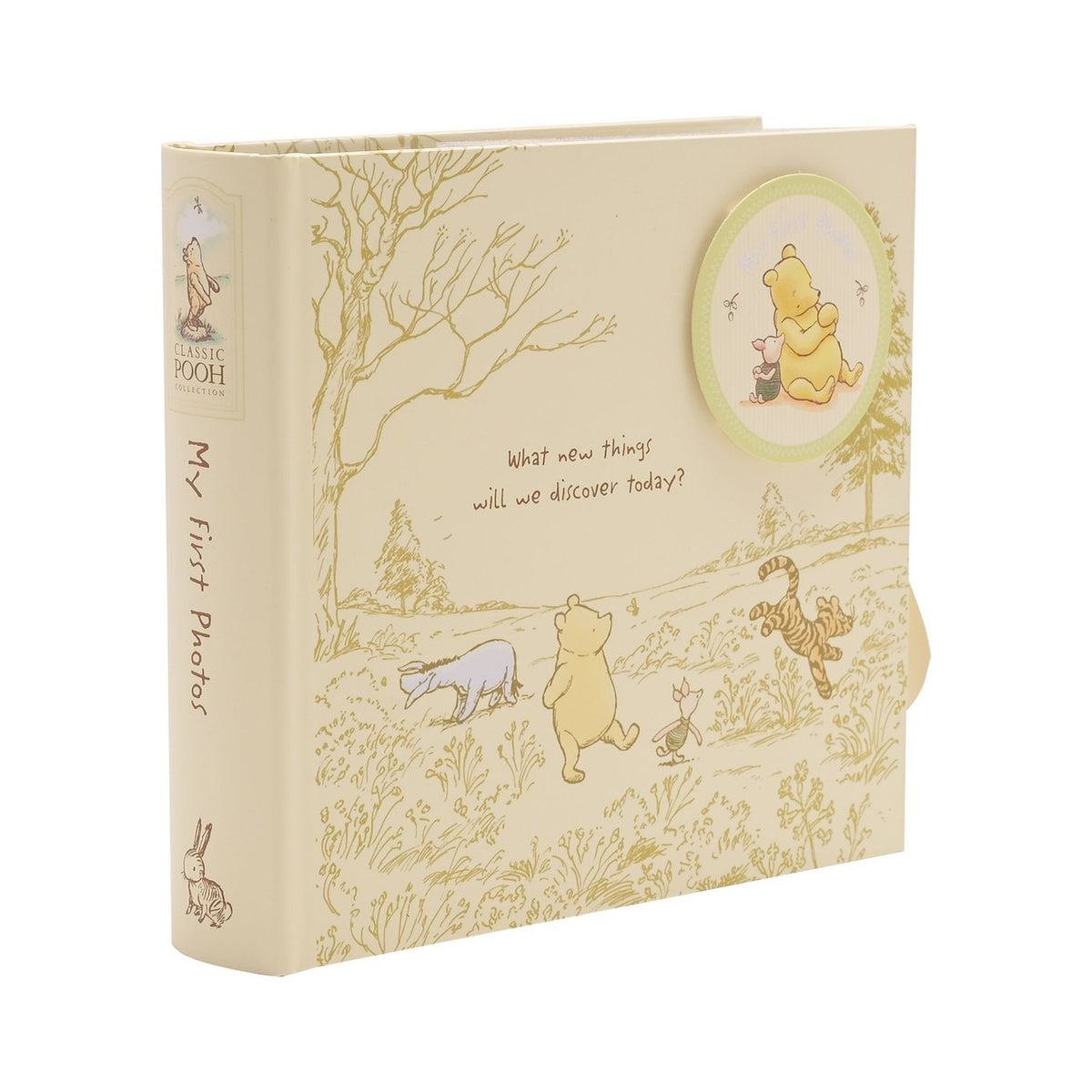 Classic Pooh My First Photos portrait photo album, cream square cover with gold line art of Pooh, Piglet, Tigger and Eeyore, round medallion image and spine text, on a white background.