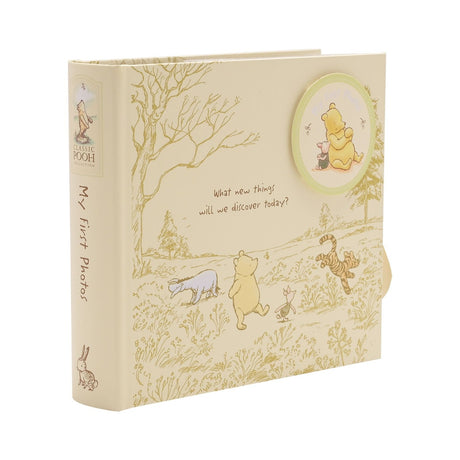 Classic Pooh My First Photos portrait photo album, cream square cover with gold line art of Pooh, Piglet, Tigger and Eeyore, round medallion image and spine text, on a white background.