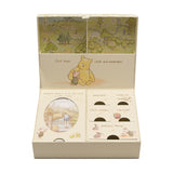 Cream rectangular Classic Pooh keepsake box, open to show printed meadow map lid, Pooh and Piglet illustration, and labelled compartments for first shoes, keepsakes, treasures, and mementos.